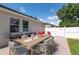 Outdoor patio dining set and barbeque grill in a fenced backyard space at 3994 Knott Dr, Apopka, FL 32712