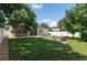 Spacious backyard features a large lawn, patio furniture, privacy fence, and mature trees at 3994 Knott Dr, Apopka, FL 32712