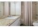 Granite vanity in a neutral bathroom with a shower/tub combination and decorative shower curtain at 3994 Knott Dr, Apopka, FL 32712