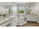 Bright bathroom featuring a soaking tub, granite counters, and modern fixtures at 3994 Knott Dr, Apopka, FL 32712