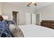 Bedroom with ensuite bathroom, featuring a ceiling fan, closet, and wood flooring at 3994 Knott Dr, Apopka, FL 32712