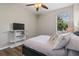 Bedroom with bright window and TV and ceiling fan at 3994 Knott Dr, Apopka, FL 32712