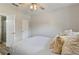 Bright bedroom featuring a ceiling fan, neutral walls, and a comfortable bed with decorative pillows at 3994 Knott Dr, Apopka, FL 32712