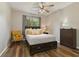 Inviting bedroom showcases wood floors, a ceiling fan, and natural light at 3994 Knott Dr, Apopka, FL 32712