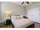 Cozy bedroom featuring a ceiling fan, stylish bedding, and a closet for ample storage space at 3994 Knott Dr, Apopka, FL 32712
