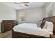 Bright bedroom featuring a dark wood bed frame, matching dresser, and a ceiling fan at 3994 Knott Dr, Apopka, FL 32712
