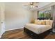 Cozy bedroom with wood floors, a large window, and comfortable bedding at 3994 Knott Dr, Apopka, FL 32712