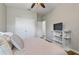 Bedroom with a ceiling fan, large closet, a TV on a stand, and neutral walls creating a relaxing atmosphere at 3994 Knott Dr, Apopka, FL 32712