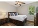 Cozy bedroom with wood-look floors, a ceiling fan, and a bed with storage drawers at 3994 Knott Dr, Apopka, FL 32712