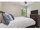 Relaxing bedroom with bright window, ceiling fan and white bedding at 3994 Knott Dr, Apopka, FL 32712