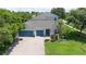 Well-maintained two-story house featuring a three-car garage, beautiful landscaping, and a spacious driveway at 3994 Knott Dr, Apopka, FL 32712