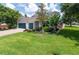 Well-maintained home featuring a two-car garage, neatly kept lawn, and attractive landscaping at 3994 Knott Dr, Apopka, FL 32712
