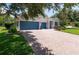 Beautiful home with a three-car garage, brick driveway, and professionally landscaped front yard at 3994 Knott Dr, Apopka, FL 32712