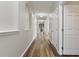 Inviting hallway with wood floors, neutral paint, arched doorways, and well-lit open spaces at 3994 Knott Dr, Apopka, FL 32712