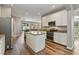 Spacious kitchen with an island, stainless steel appliances, granite countertops, and white cabinetry at 3994 Knott Dr, Apopka, FL 32712