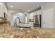 Close-up of kitchen countertops and sink featuring stainless steel appliances, granite countertops, and white cabinetry at 3994 Knott Dr, Apopka, FL 32712