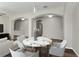 Open-concept living room with wood floors, a modern round table, and a relaxing seating area at 3994 Knott Dr, Apopka, FL 32712