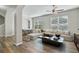Bright living room with wood floors, a large sectional sofa, and views through the window at 3994 Knott Dr, Apopka, FL 32712
