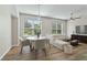 Cozy living room featuring wood floors, a round marble table, and a comfortable sectional sofa at 3994 Knott Dr, Apopka, FL 32712