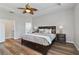 Main bedroom with a large bed, tray ceiling, and ensuite bathroom at 3994 Knott Dr, Apopka, FL 32712