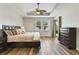 Comfortable main bedroom with tray ceiling, fan, and backyard access at 3994 Knott Dr, Apopka, FL 32712