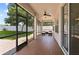 Spacious screened patio with ceiling fan and outdoor seating, overlooking a landscaped backyard at 3994 Knott Dr, Apopka, FL 32712