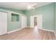 Bright bedroom featuring light green walls, wood floors, and a ceiling fan at 4085 Cypress Bend, Geneva, FL 32732