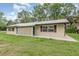 A charming, ranch-style home with a metal roof, geometric details, and a well-maintained lawn at 4085 Cypress Bend, Geneva, FL 32732