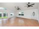 Bright, spacious living room with tile flooring, abundant windows, and stylish ceiling fans for ultimate comfort at 4085 Cypress Bend, Geneva, FL 32732