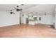 Open-concept living space with bright white walls, tile floors, ceiling fans, and seamless flow to the kitchen at 4085 Cypress Bend, Geneva, FL 32732