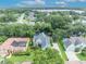 Drone view of property showcasing its location among mature trees, nearby lake and beautiful neighborhood at 413 Harbour Oaks Pointe Dr, Edgewood, FL 32809