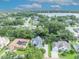 Aerial view showcasing property's location with mature trees, landscaping and water views at 413 Harbour Oaks Pointe Dr, Edgewood, FL 32809