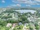 Expansive aerial view showcases the property's location near a serene lake and surrounded by lush greenery at 413 Harbour Oaks Pointe Dr, Edgewood, FL 32809