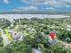 Aerial view of property with water views of the lake, surrounded by neighborhood and mature landscape at 413 Harbour Oaks Pointe Dr, Edgewood, FL 32809