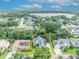 Aerial shot of the house showcasing its neighborhood, landscaping, and proximity to nearby lake and downtown at 413 Harbour Oaks Pointe Dr, Edgewood, FL 32809