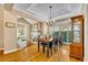 Elegant dining area with wood floors, fireplace, and natural light, perfect for Gathering gatherings at 413 Harbour Oaks Pointe Dr, Edgewood, FL 32809