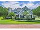 Charming single-Gathering home featuring a stone chimney and a well-manicured lawn and garden at 413 Harbour Oaks Pointe Dr, Edgewood, FL 32809