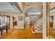 Elegant foyer showcasing hardwood floors, arched doorways, a staircase, and stylish decor at 413 Harbour Oaks Pointe Dr, Edgewood, FL 32809