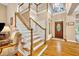 Grand foyer with elegant staircase, hardwood floors, and abundant natural light at 413 Harbour Oaks Pointe Dr, Edgewood, FL 32809