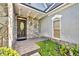 Inviting front entrance featuring a stone facade, decorative door, and manicured landscaping at 413 Harbour Oaks Pointe Dr, Edgewood, FL 32809