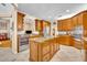 Spacious kitchen with granite countertops, stainless steel appliances, and a large center island at 413 Harbour Oaks Pointe Dr, Edgewood, FL 32809