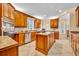 Well-lit kitchen with custom wood cabinets, stainless steel appliances, and a functional center island at 413 Harbour Oaks Pointe Dr, Edgewood, FL 32809