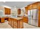 Open kitchen featuring wood cabinetry, stainless appliances, granite countertops and a central island at 413 Harbour Oaks Pointe Dr, Edgewood, FL 32809