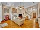 Bright and inviting living room featuring a fireplace, hardwood floors, and a staircase at 413 Harbour Oaks Pointe Dr, Edgewood, FL 32809