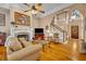 Inviting living room with fireplace, hardwood floors, and a staircase leading to the upper level at 413 Harbour Oaks Pointe Dr, Edgewood, FL 32809