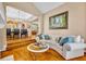 Comfortable living room with hardwood floors, stylish furnishings, and a view into the dining area at 413 Harbour Oaks Pointe Dr, Edgewood, FL 32809