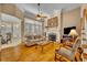 Cozy living room with hardwood floors, fireplace, comfortable seating, and lots of natural light at 413 Harbour Oaks Pointe Dr, Edgewood, FL 32809
