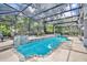 Enclosed pool area featuring a beautifully tiled pool, lounge chairs, and a view of the greenery at 413 Harbour Oaks Pointe Dr, Edgewood, FL 32809