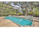 Beautiful screened-in pool with rock features, surrounded by mature trees offering privacy and shade at 413 Harbour Oaks Pointe Dr, Edgewood, FL 32809