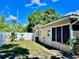 Well-maintained backyard with a white fence, small plants, and the rear exterior of the house at 435 Andes Ave, Orlando, FL 32807